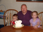 Brandon, Grandpa, and Kayla with the bunny cake