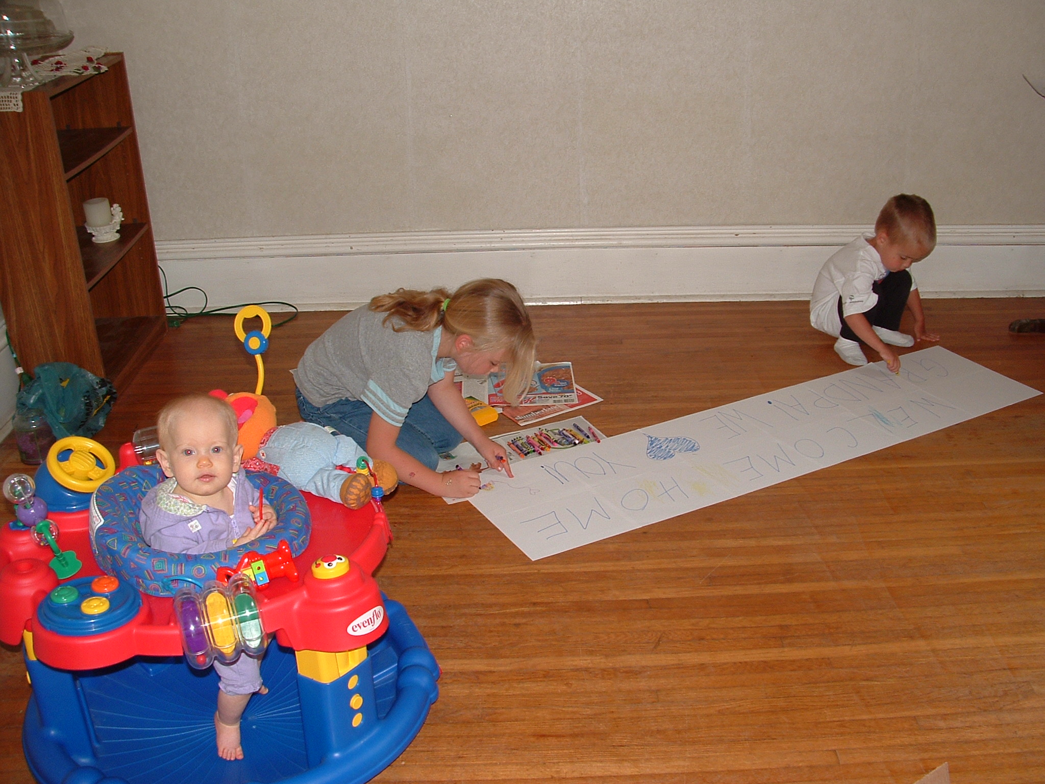 Brandon and Kayla making a sign, Ellie supervising.