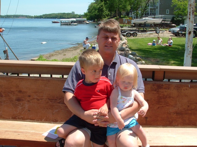 Sitting outside the restaurant.  Looks like a couple tired kids!